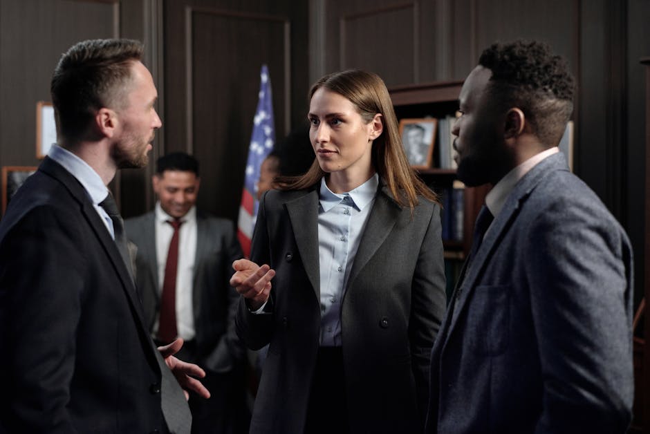 A diverse group of business professionals engaged in a discussion in an office
