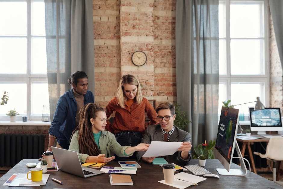 A diverse team of young professionals working on a business strategy in an urban office setting